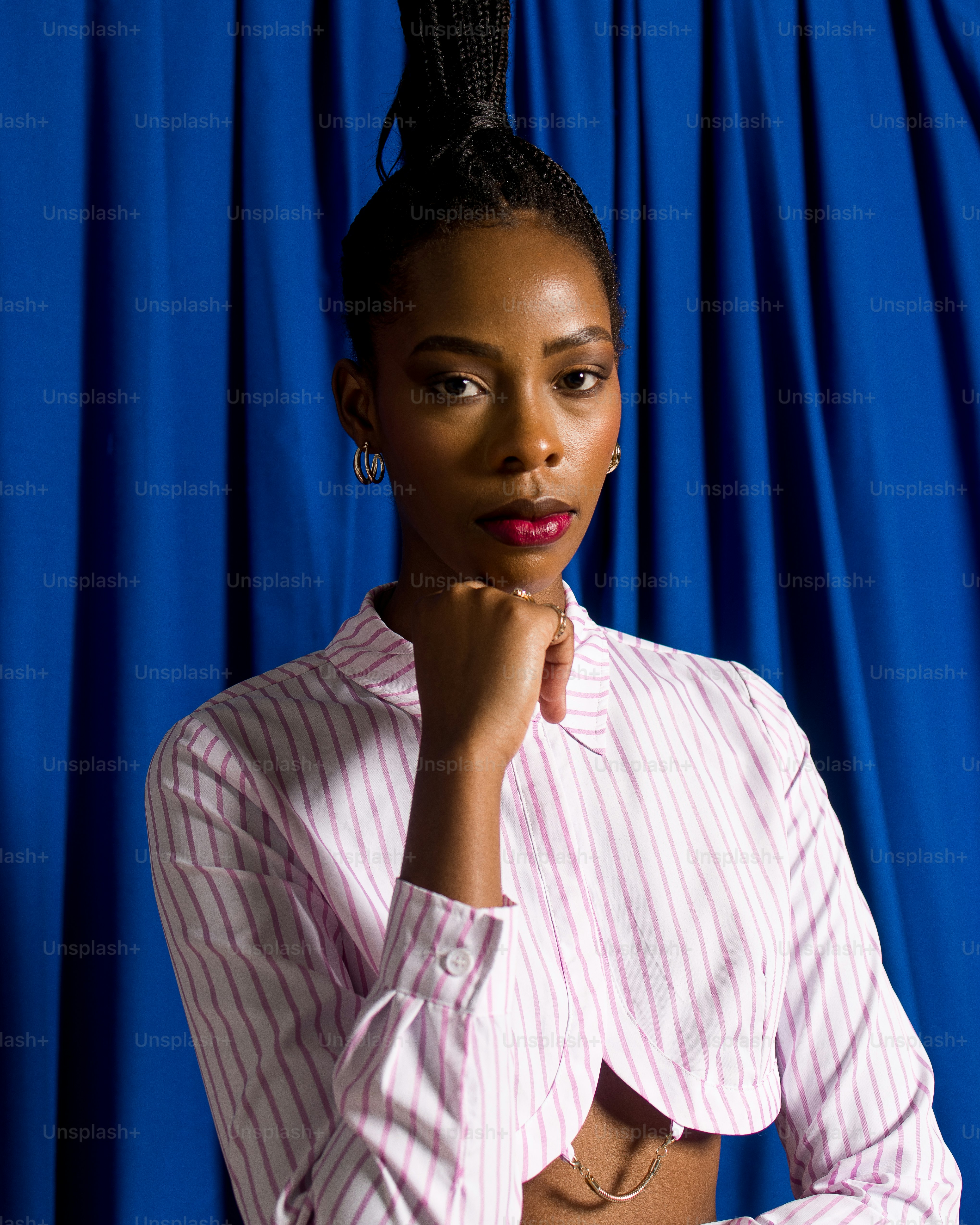 a woman in a pink shirt is posing for a picture