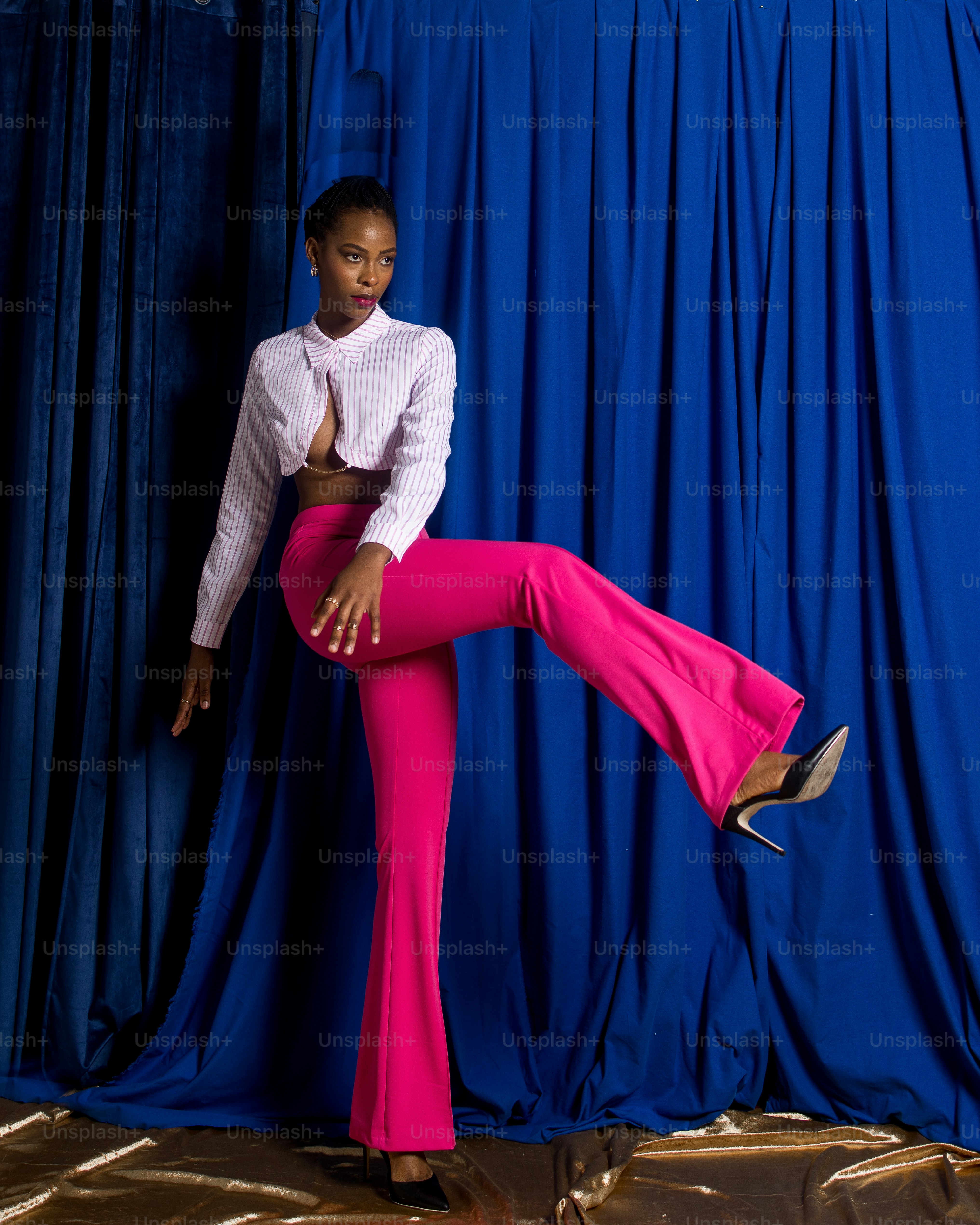 a woman in a white shirt and pink pants