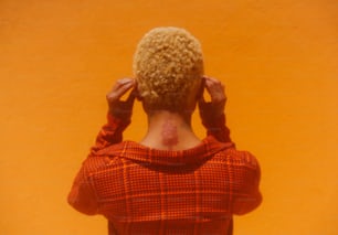 a woman in a red sweater with her back to the camera