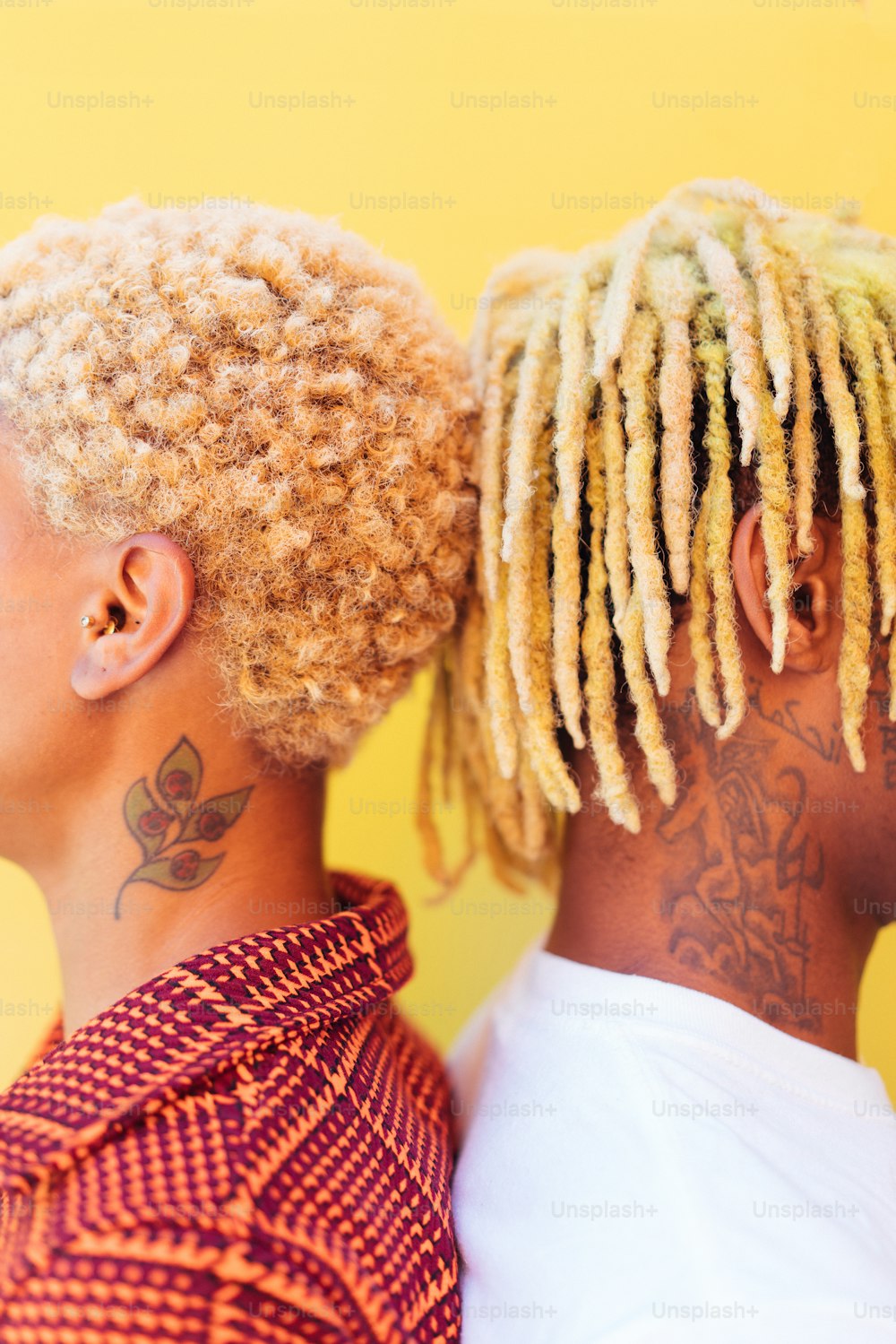 a couple of people with dreadlocks standing next to each other