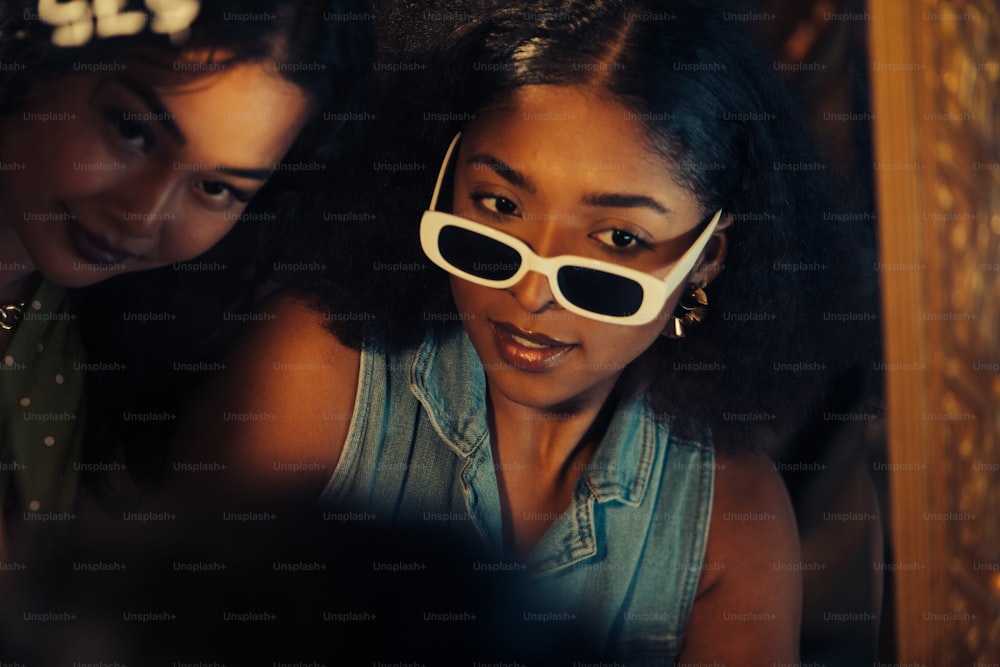 two young women with sunglasses on their faces