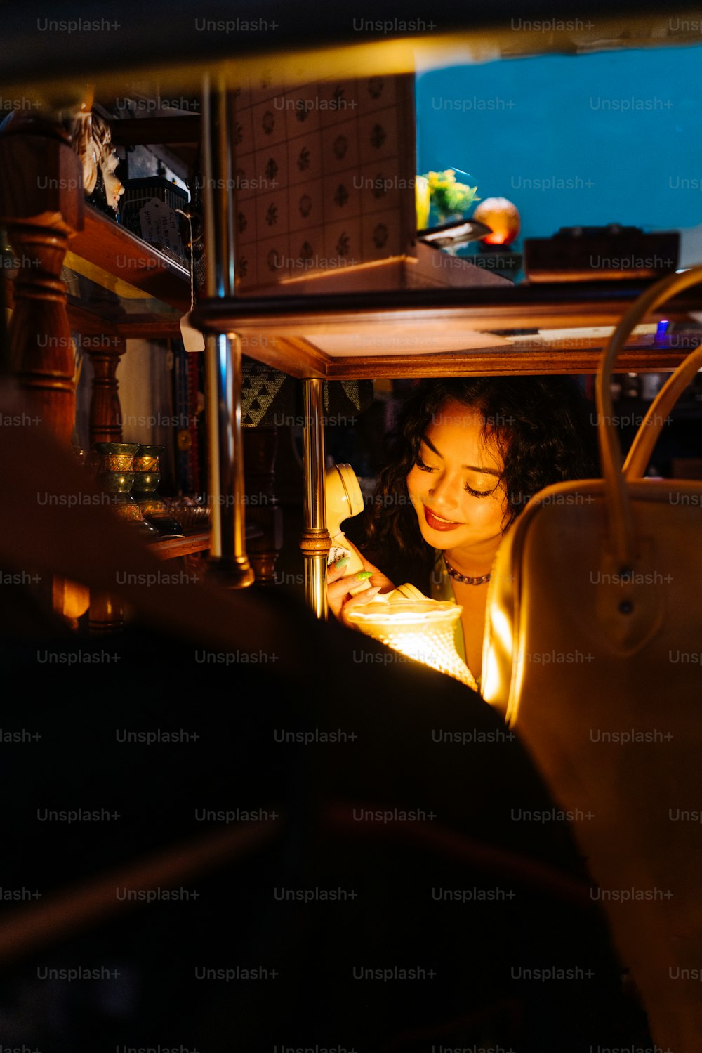 a woman looking at a cell phone in the dark