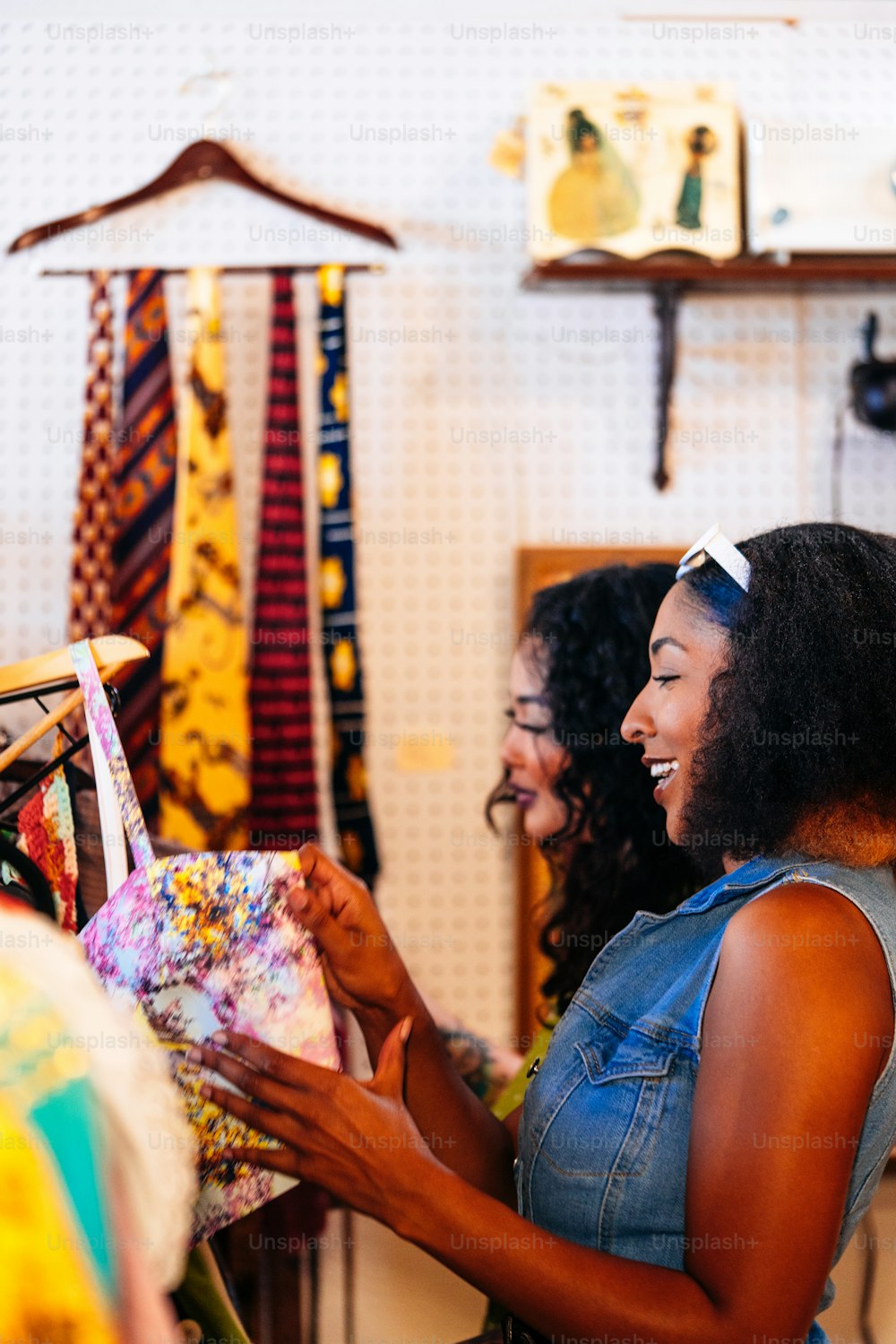 a woman is looking at a piece of cloth