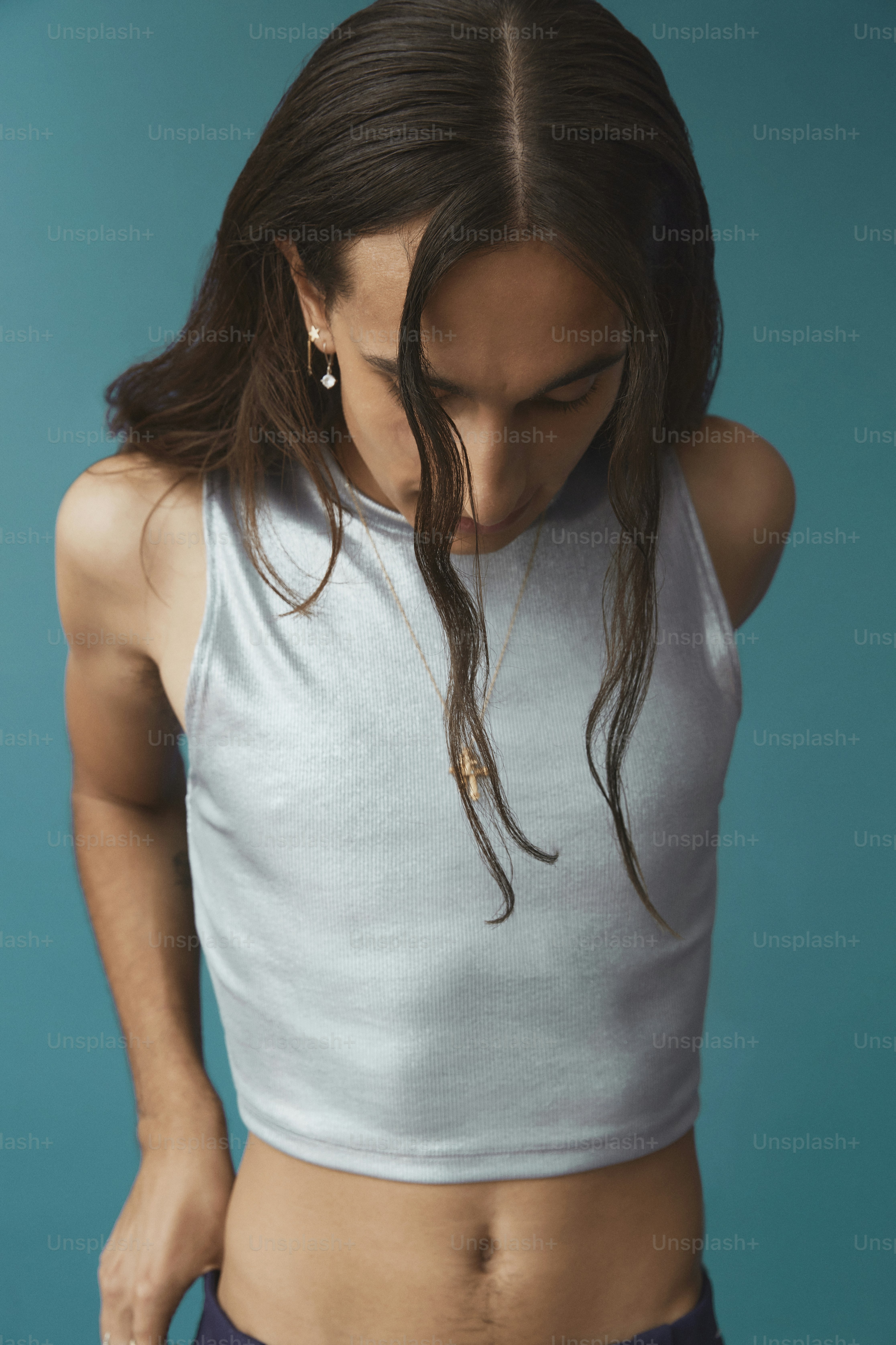 a woman in a crop top holding her stomach