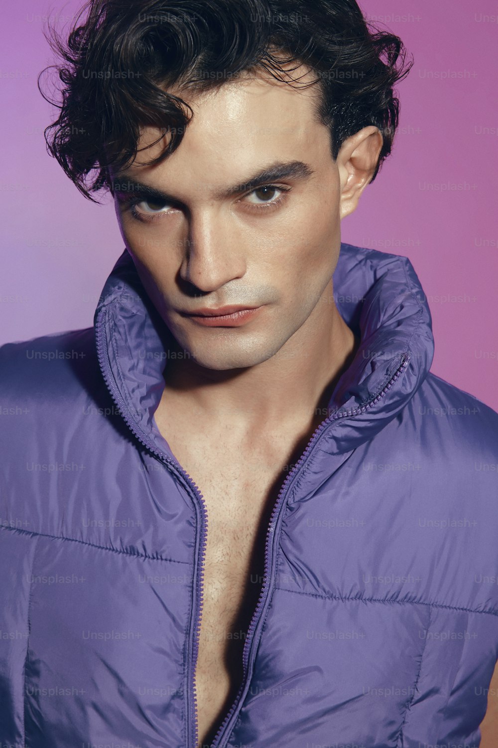 a man in a purple jacket posing for a picture