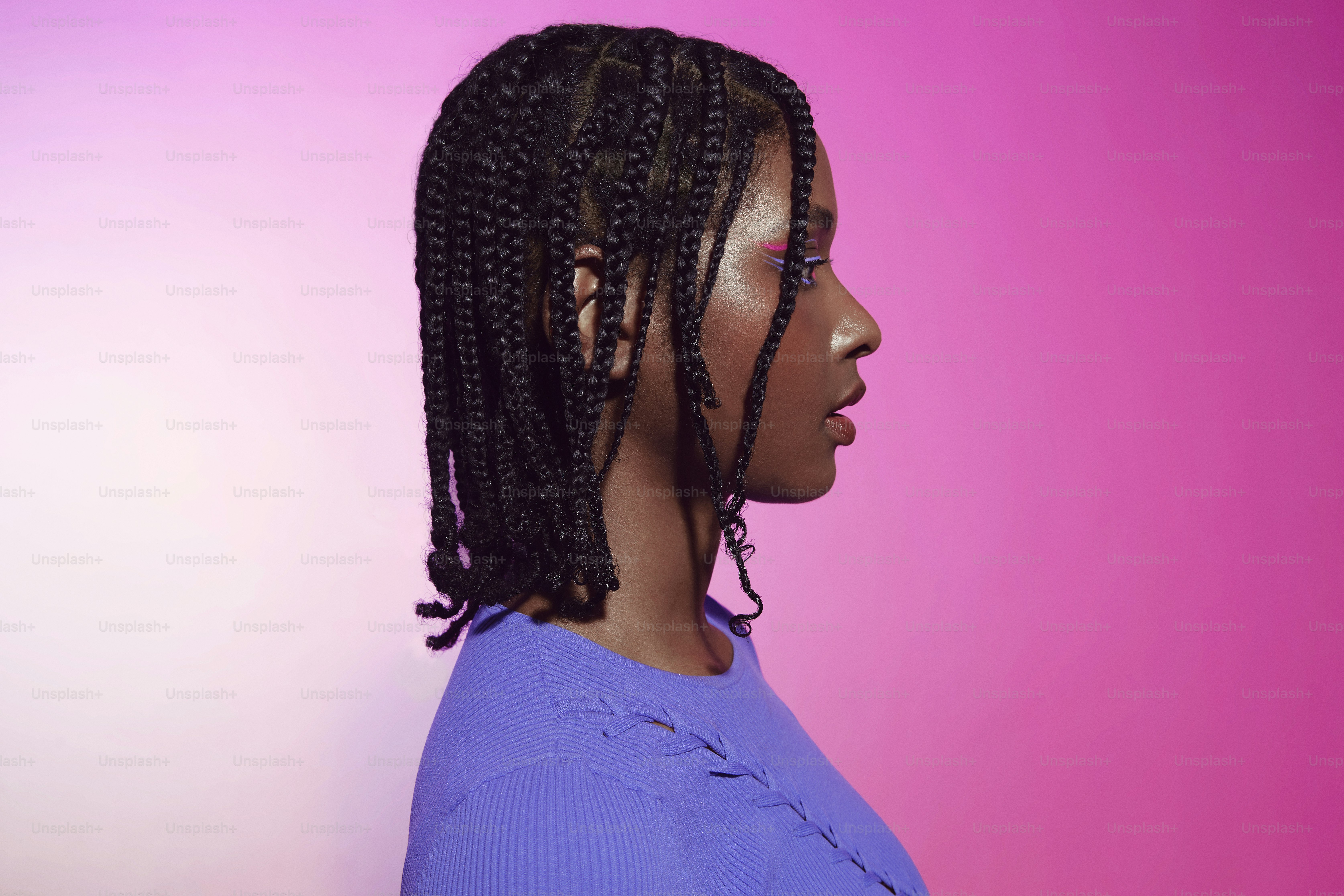 a woman with a purple shirt and a pink background