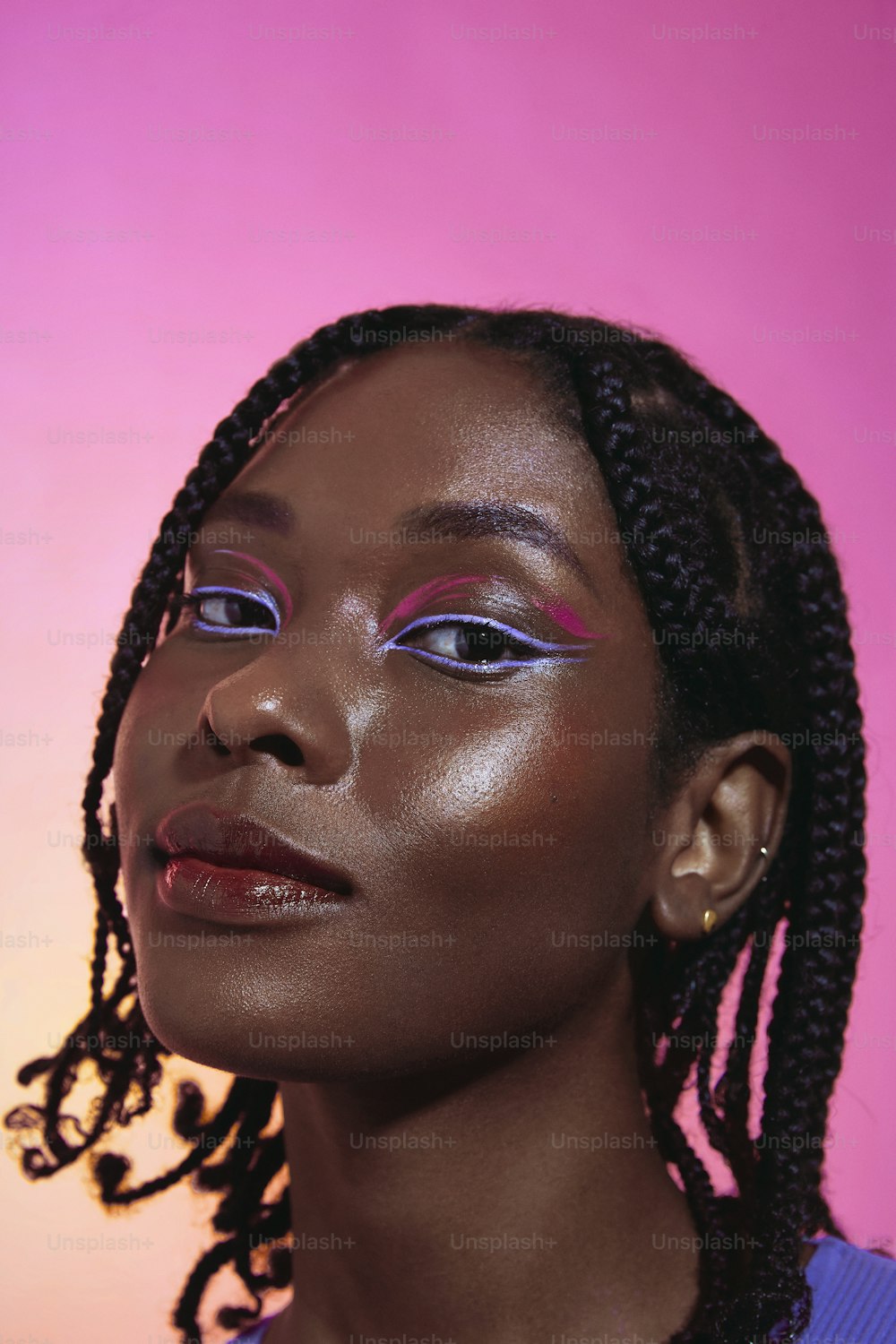 a woman with braids and purple eyeshadow