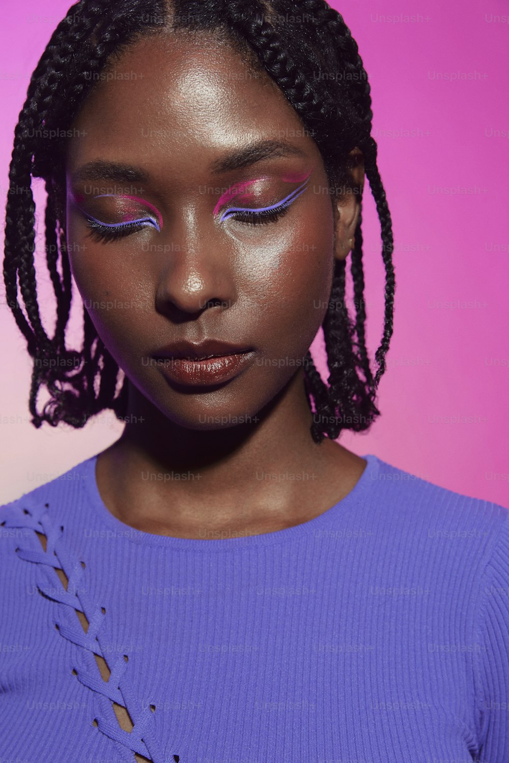 a woman with purple eyeshadow and braids