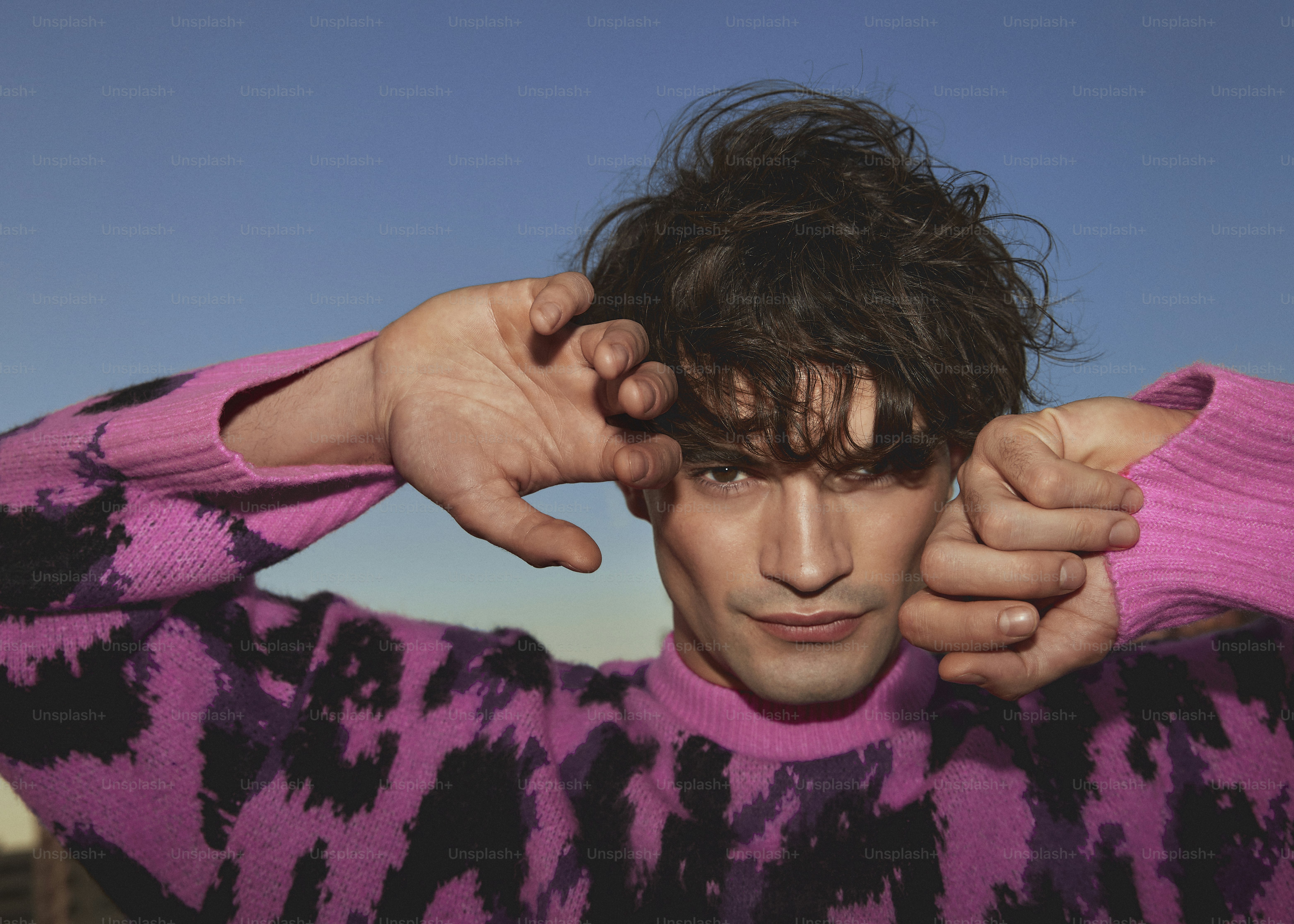 a man with his hands on his head