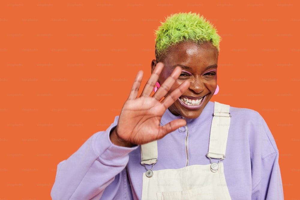 a woman with green hair making a peace sign