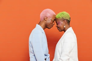 a man and a woman with pink and green hair