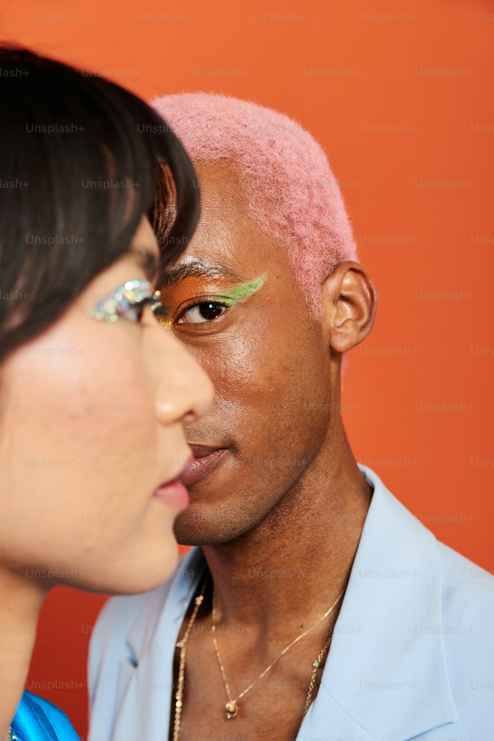a man and a woman with pink hair