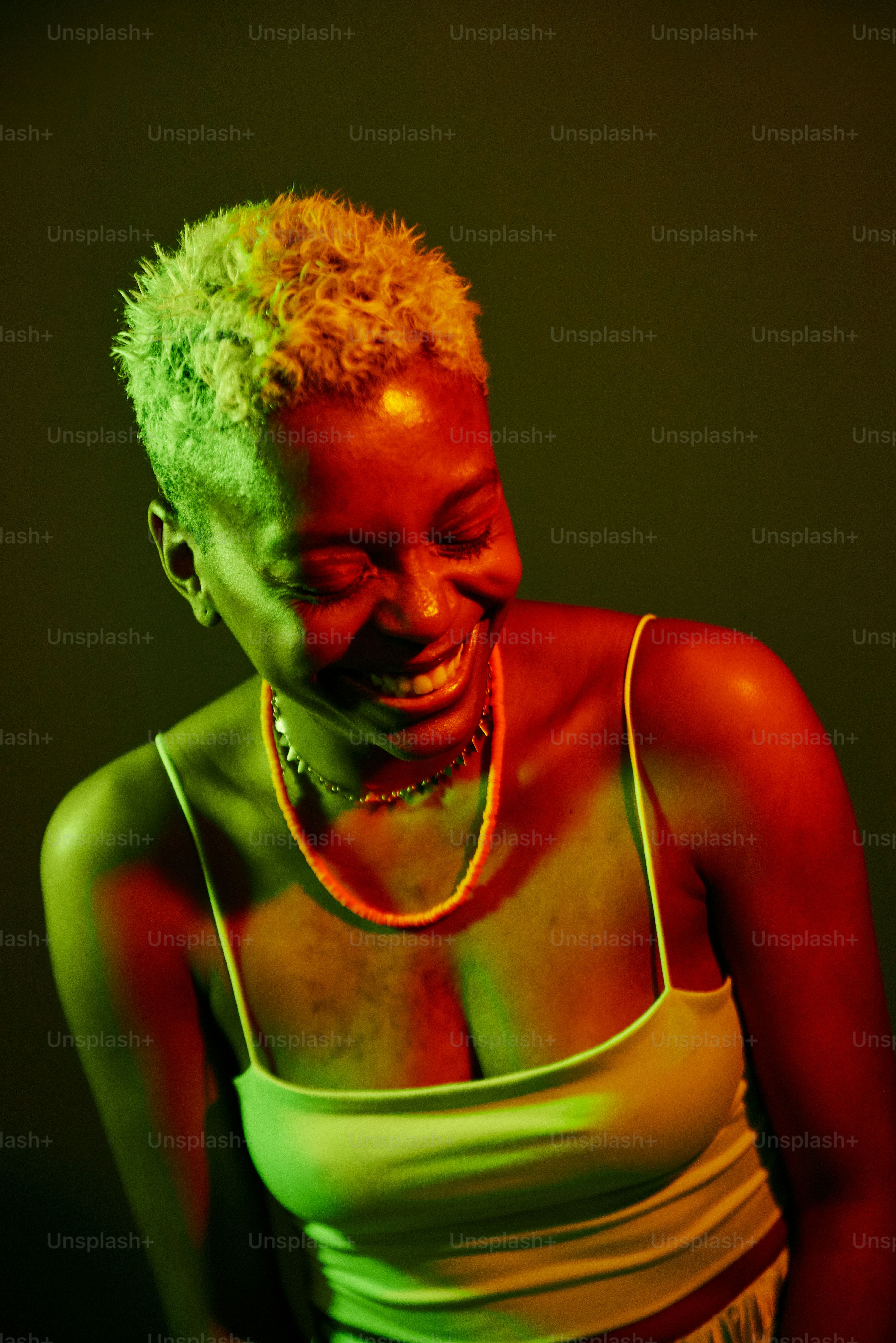 a woman in a green tank top smiling