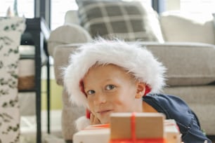 a small child wearing a santa hat and playing with blocks