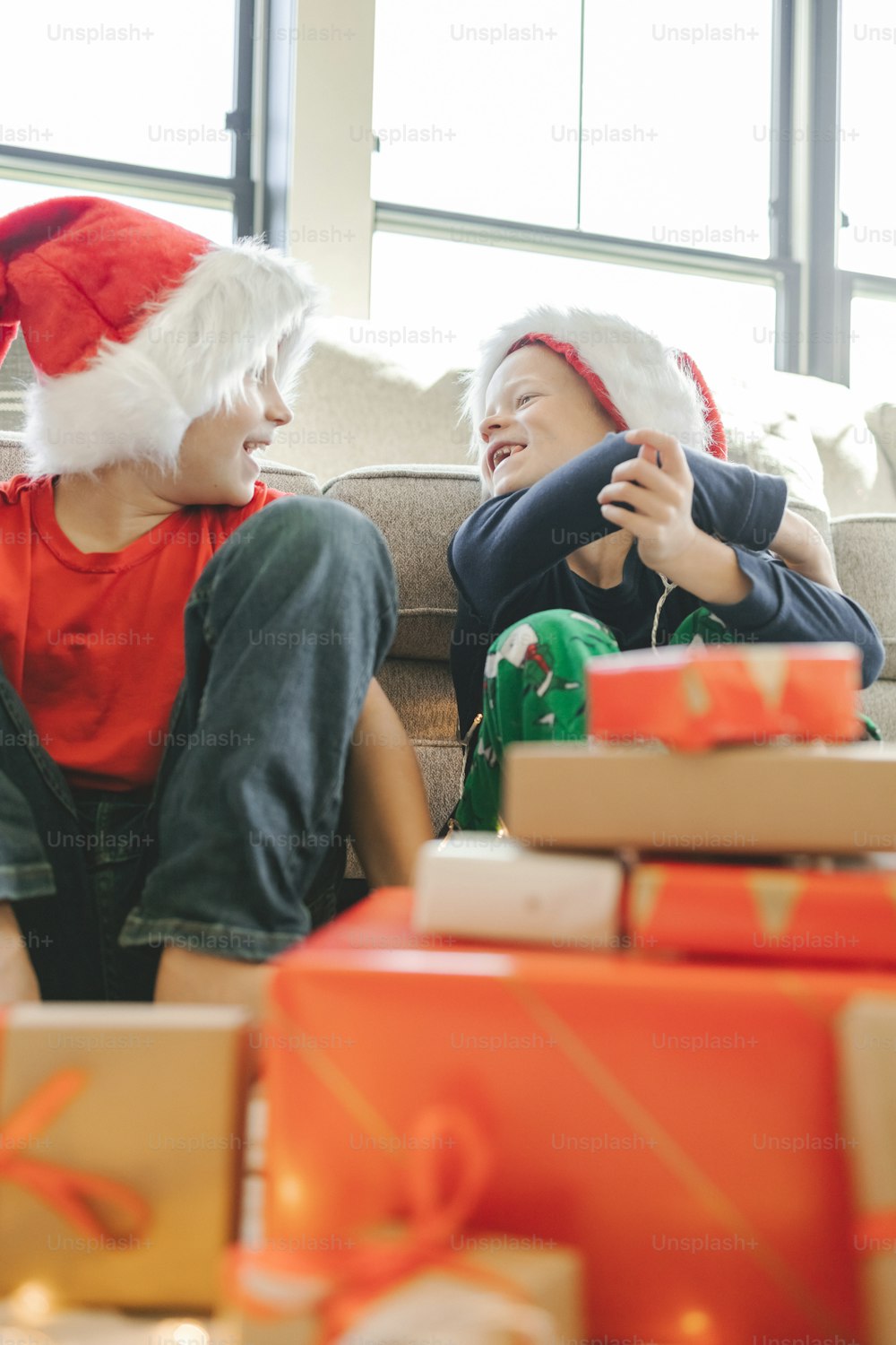 a couple of kids sitting on top of a couch