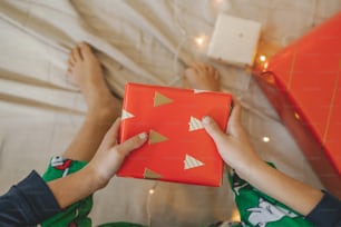 a person holding a red box with gold triangles on it