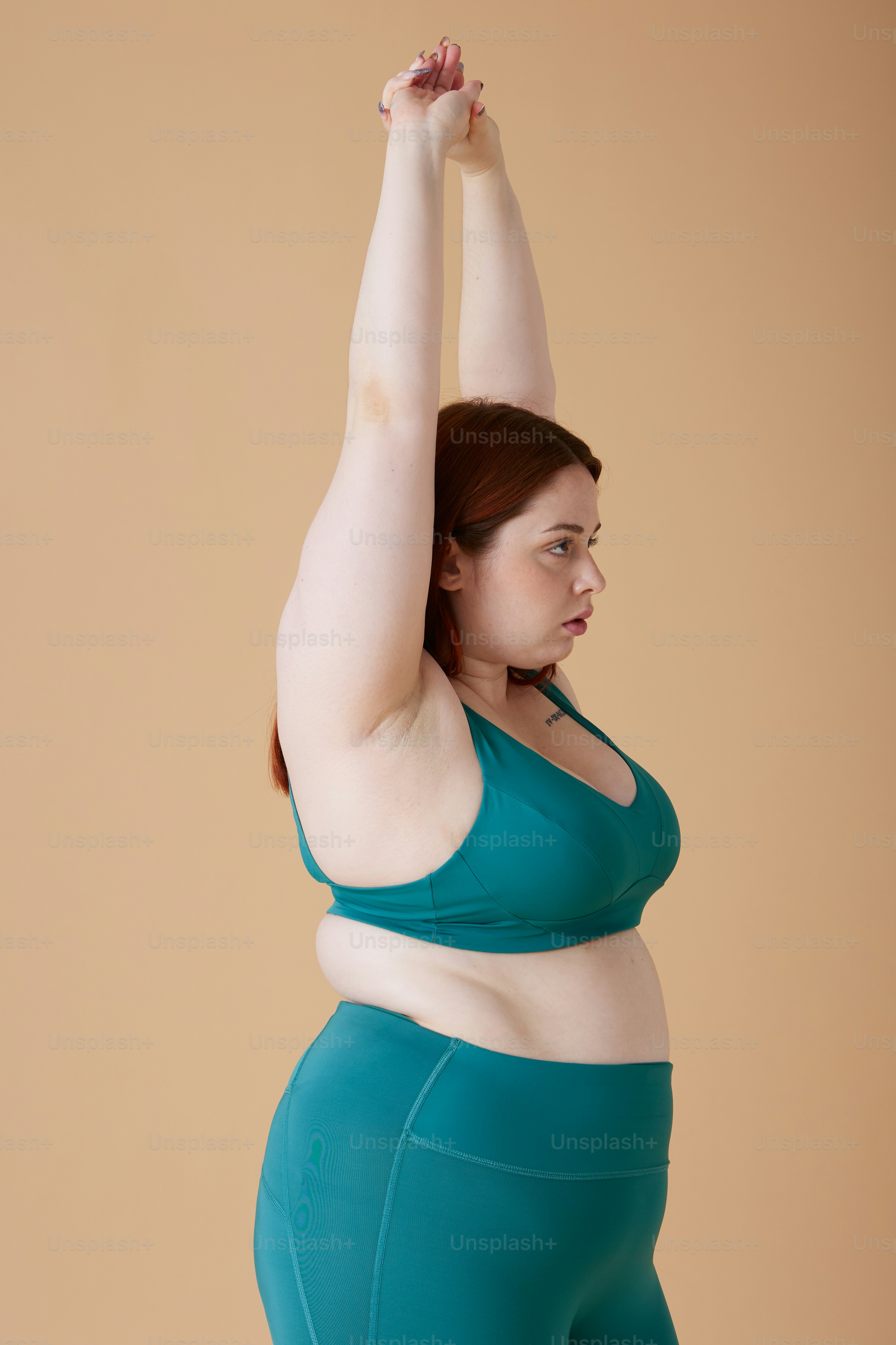 a woman in a green top and blue shorts