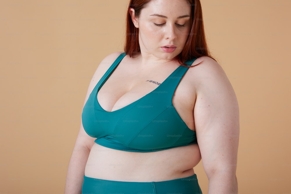 a woman in a green bikini top with her eyes closed