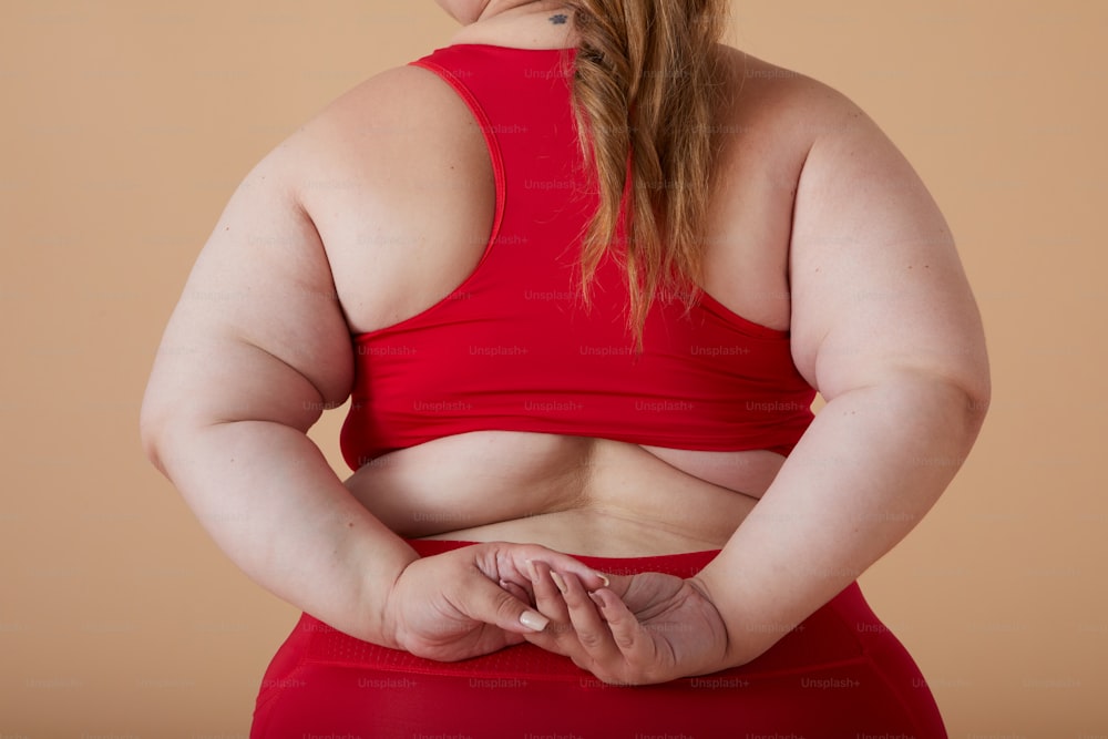a woman in a red top with her hands on her hips