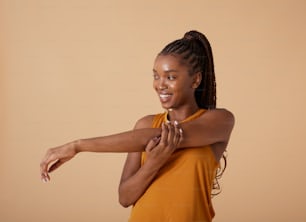 a woman in an orange shirt is dancing