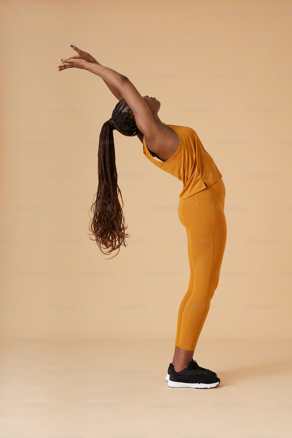 a woman is doing a handstand with her hair in the air