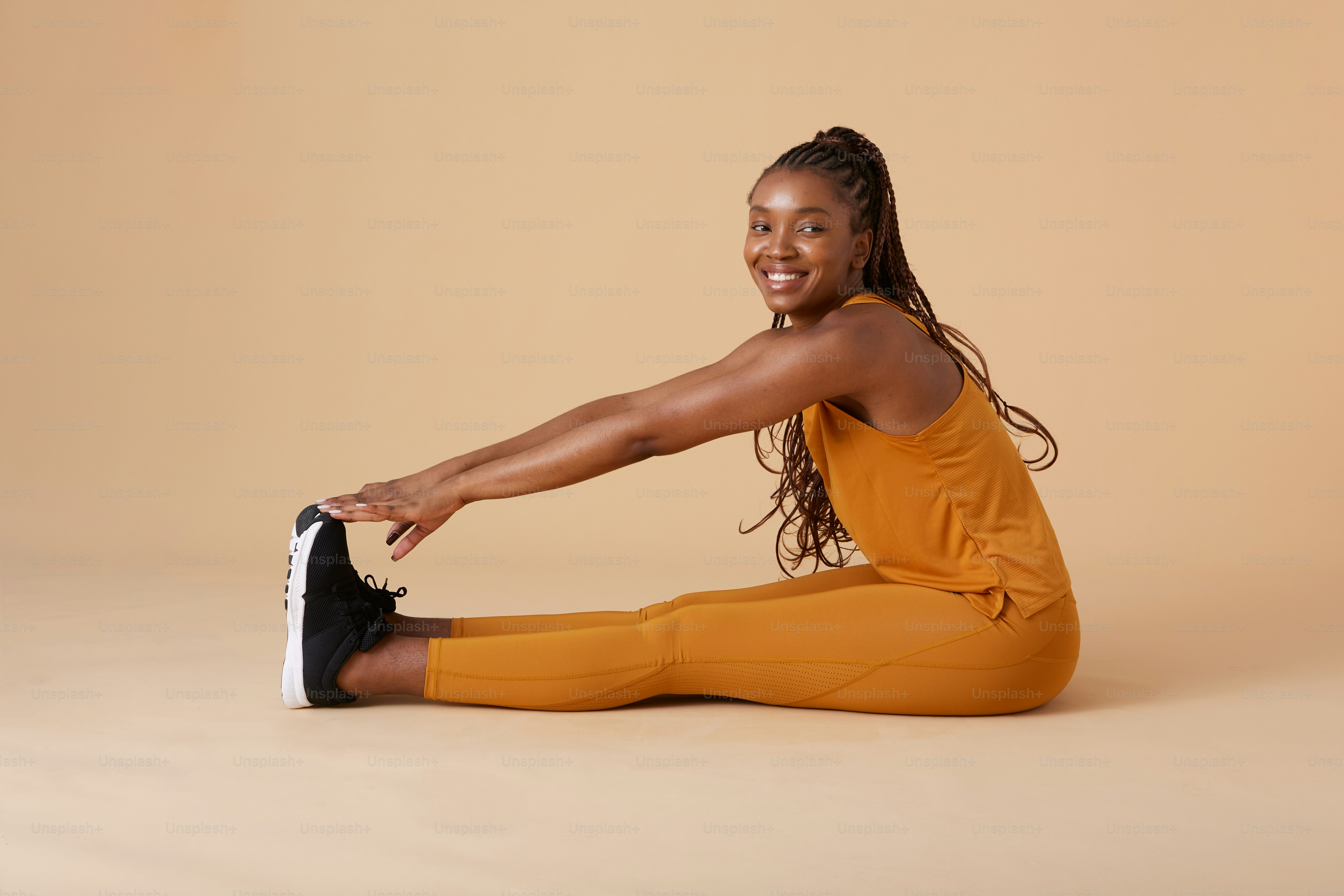 a woman is sitting on the floor and smiling