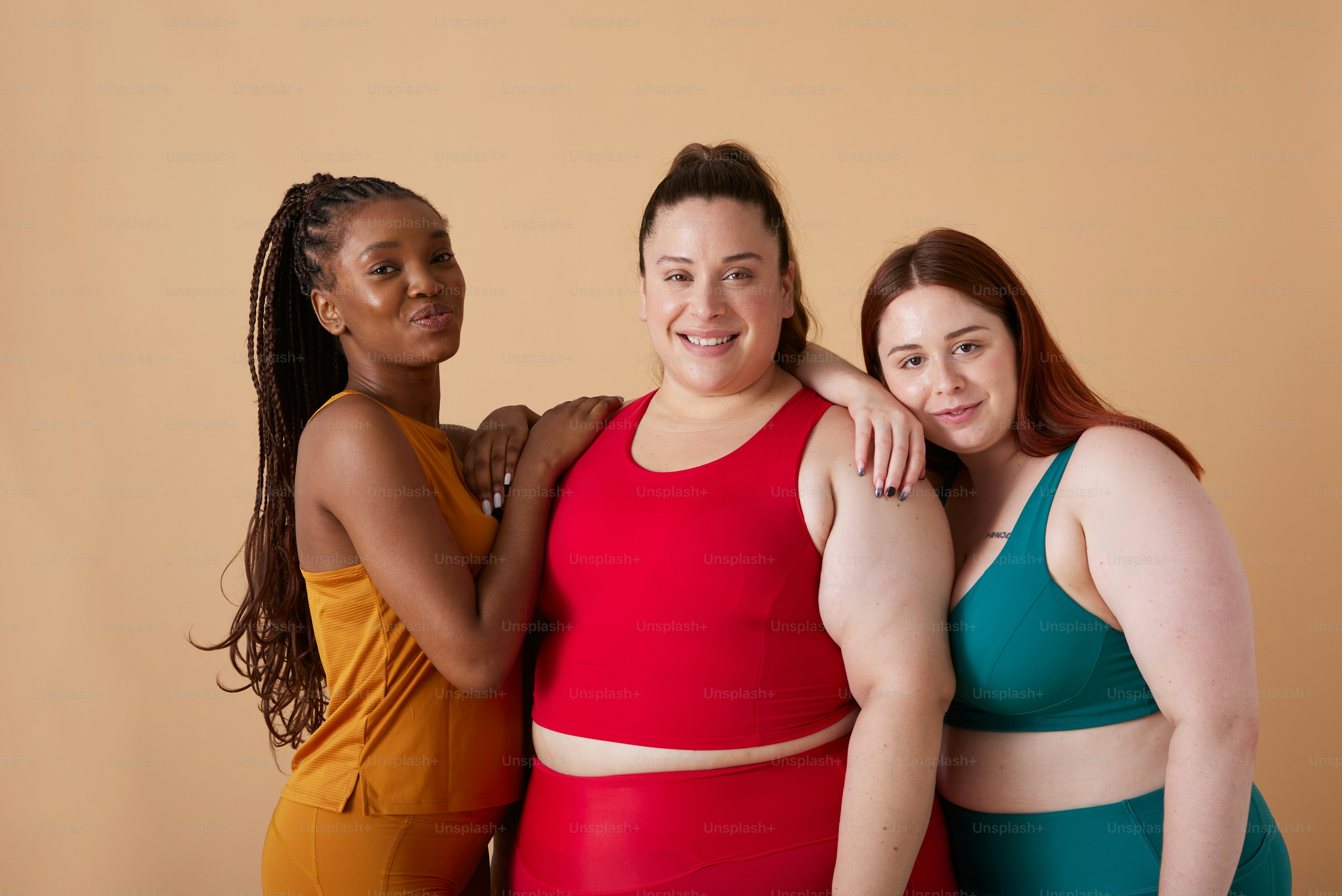 a group of three women standing next to each other