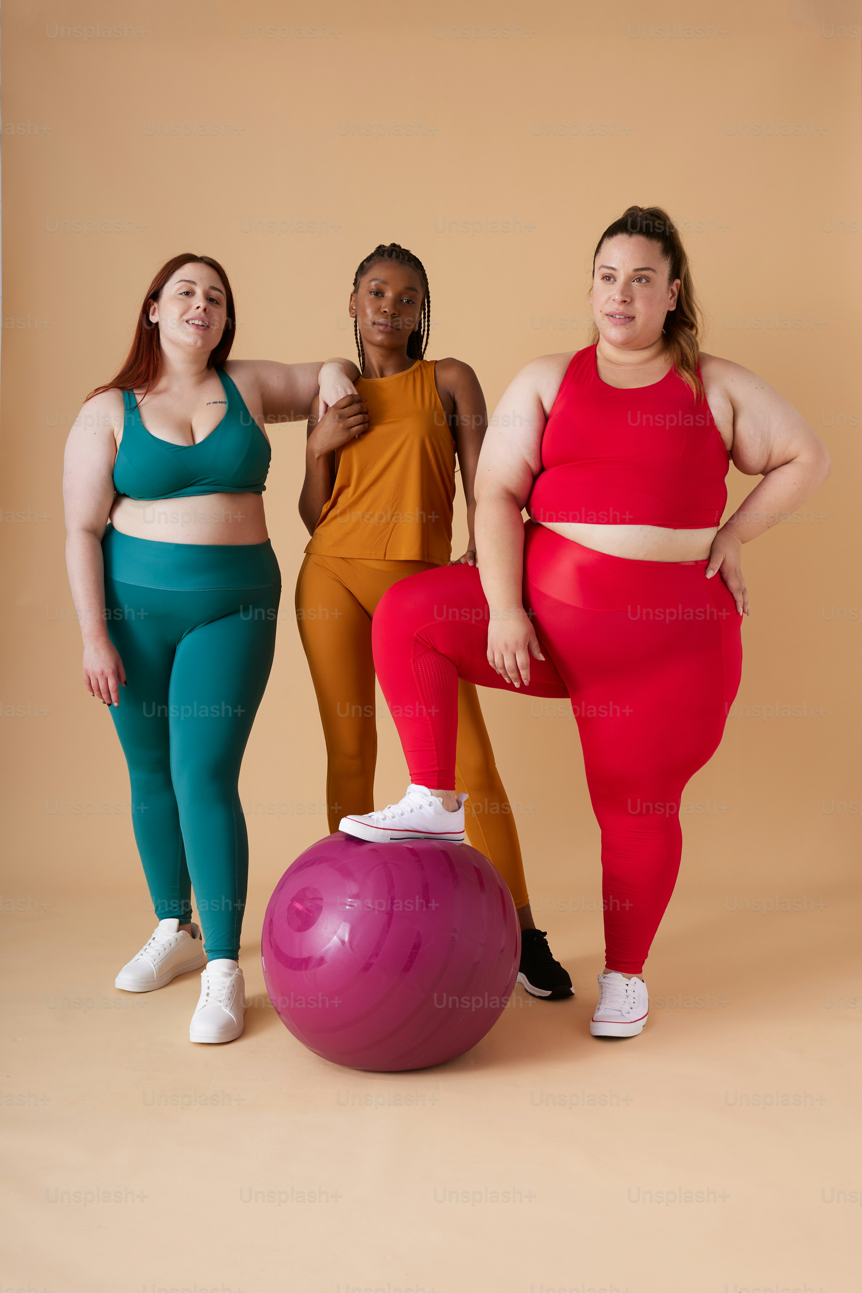 a group of three women standing next to each other