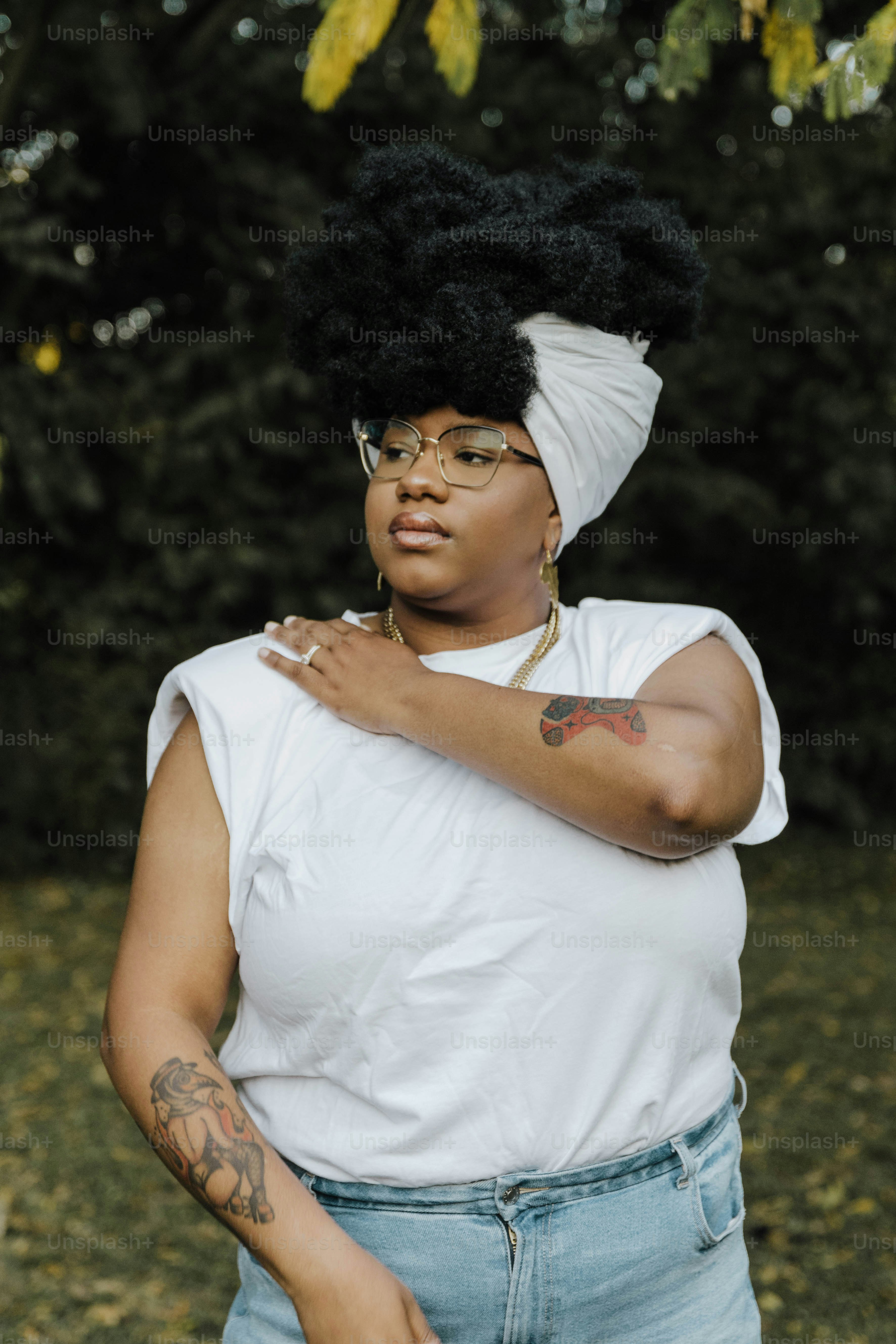 a woman wearing a white shirt and a black and white turban