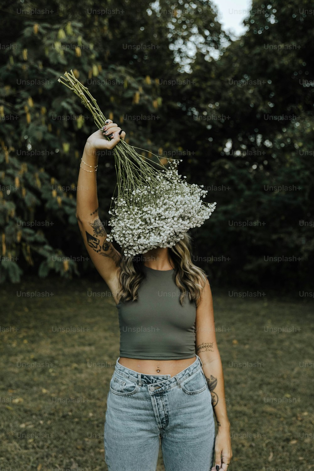 Une femme tenant un bouquet de fleurs sur sa tête
