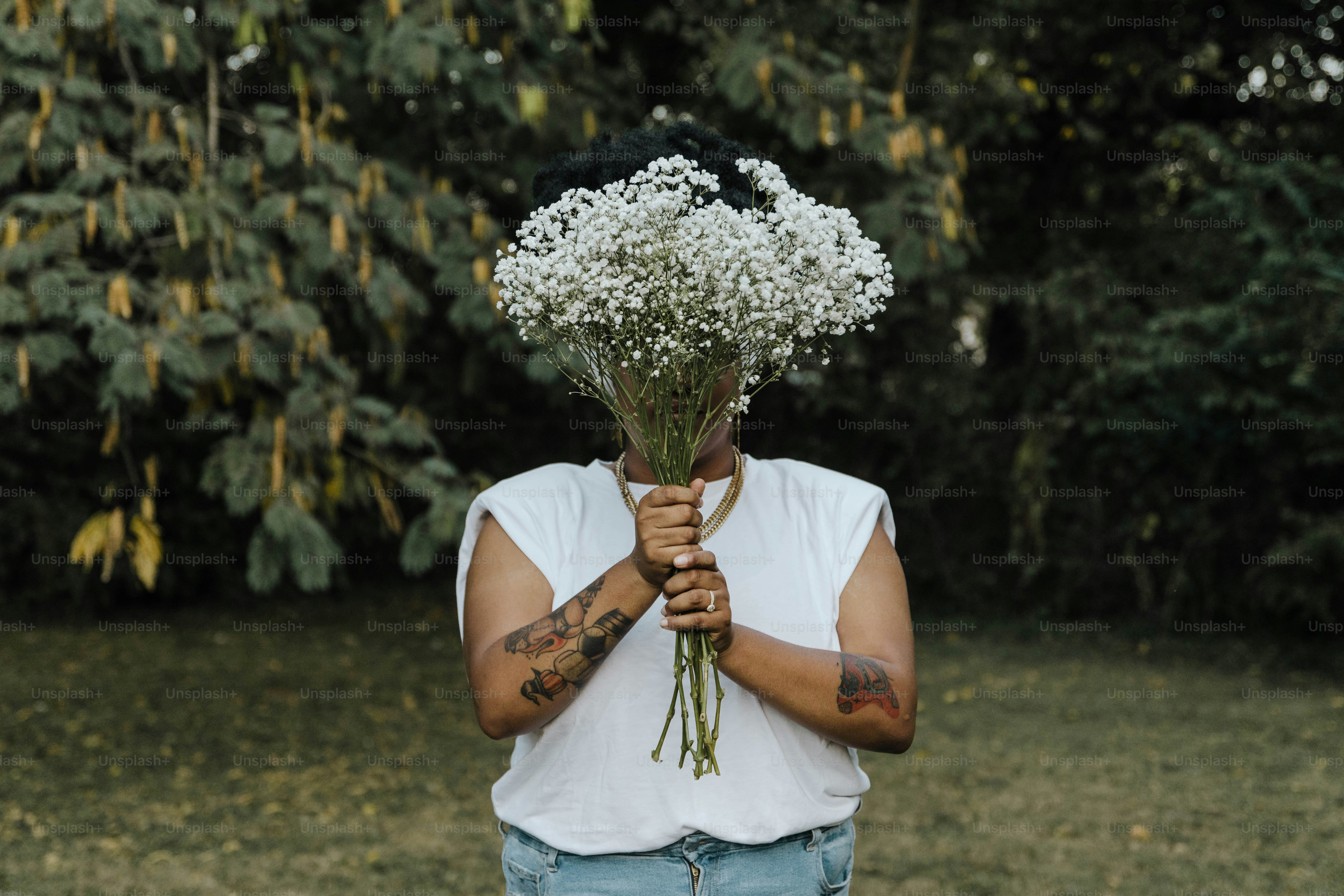 a man holding a bunch of flowers in his hands