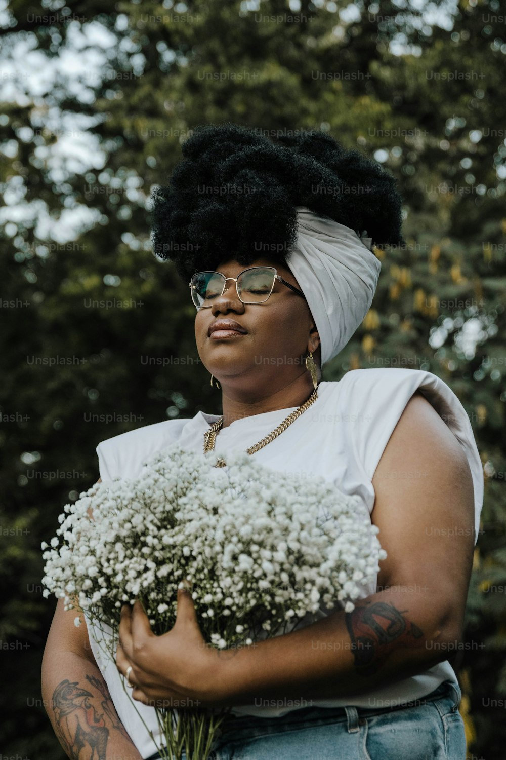 a woman holding a bunch of flowers in her hands