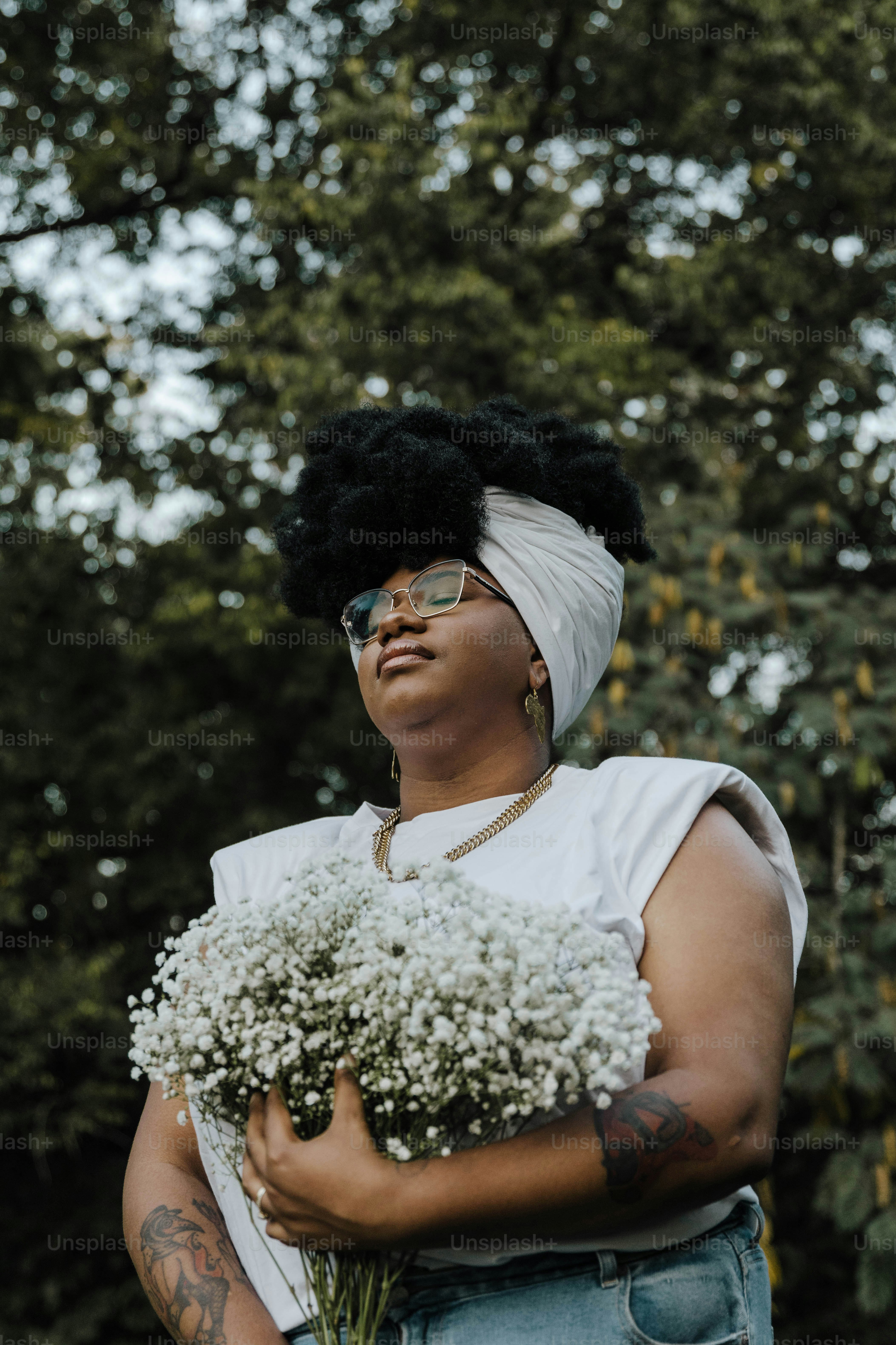 a woman holding a bunch of flowers in her hands