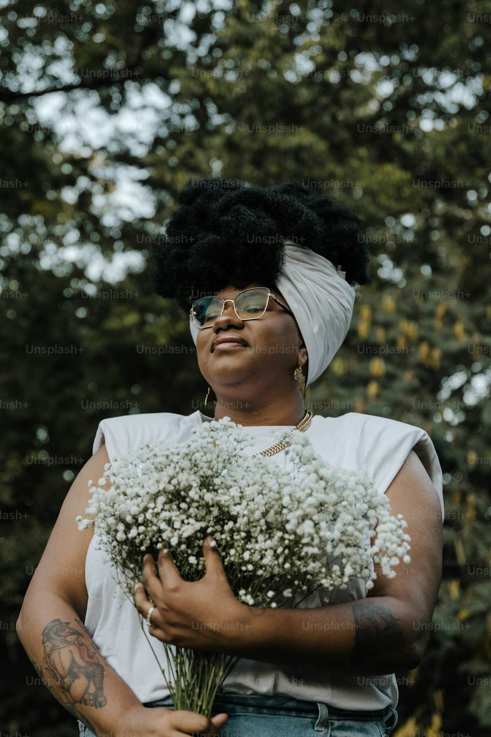a woman holding a bunch of flowers in her hands