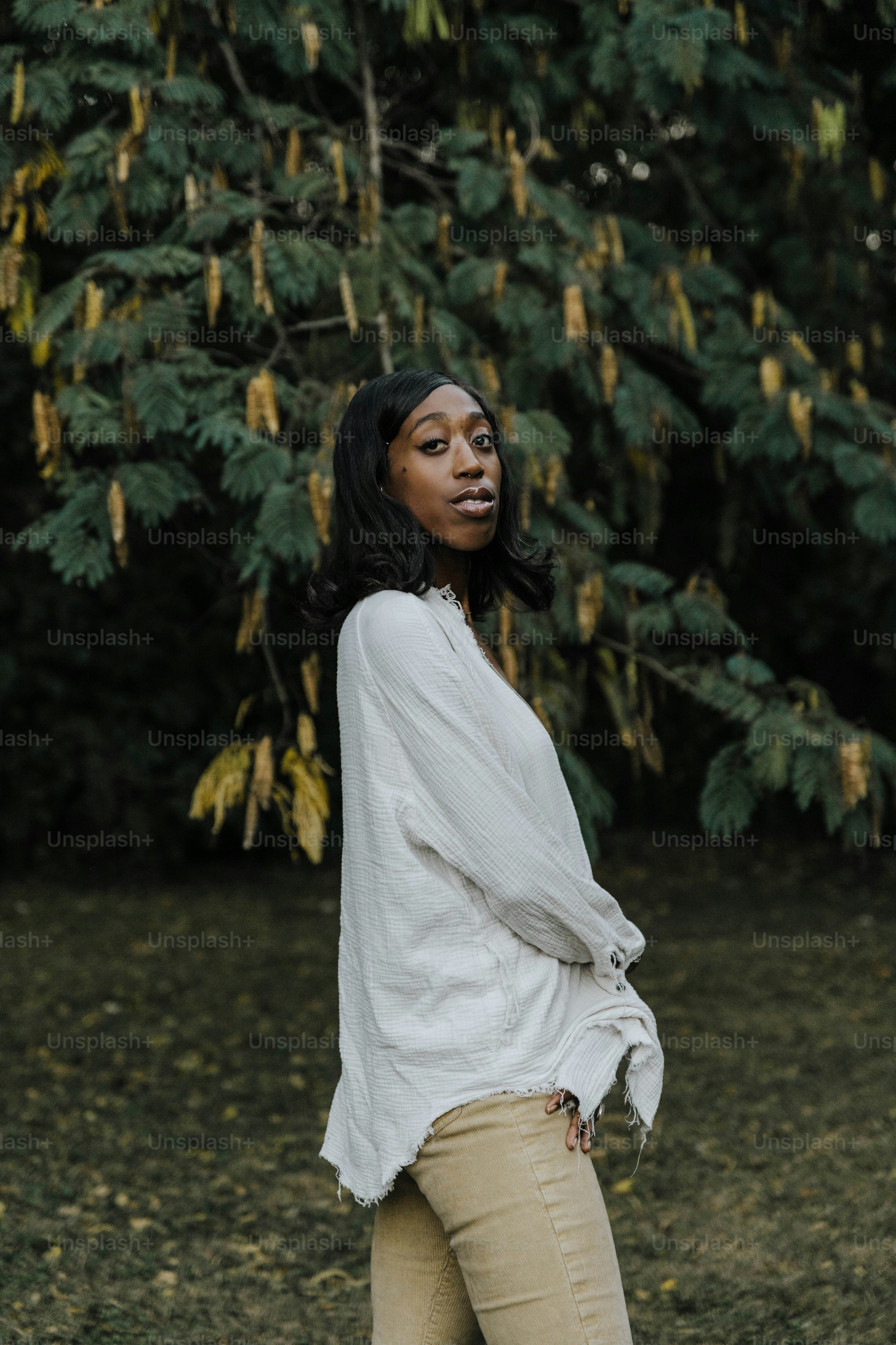 A woman standing in front of a tree photo – Black female Image on Unsplash