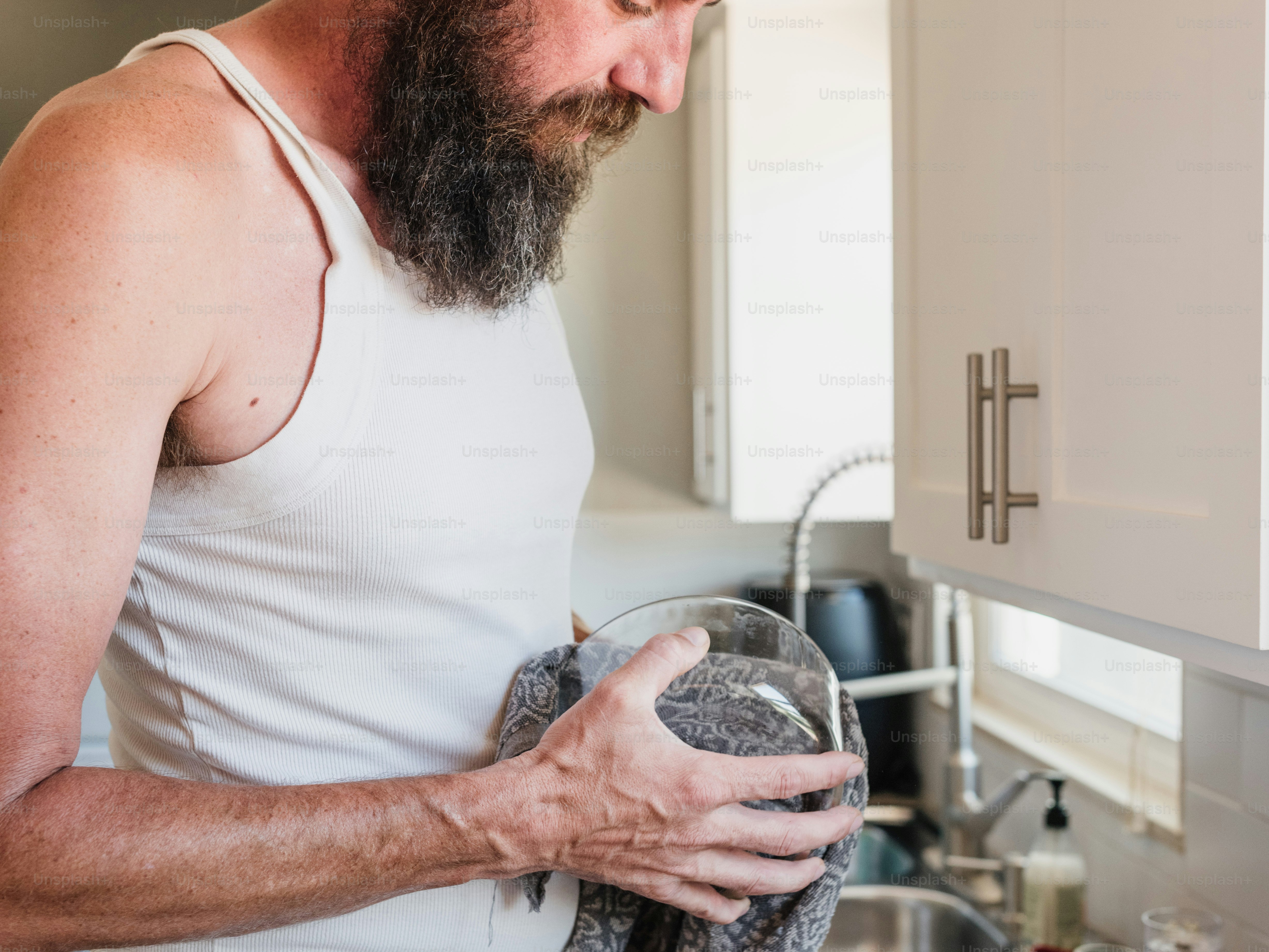 a man with a beard holding a glass of water
