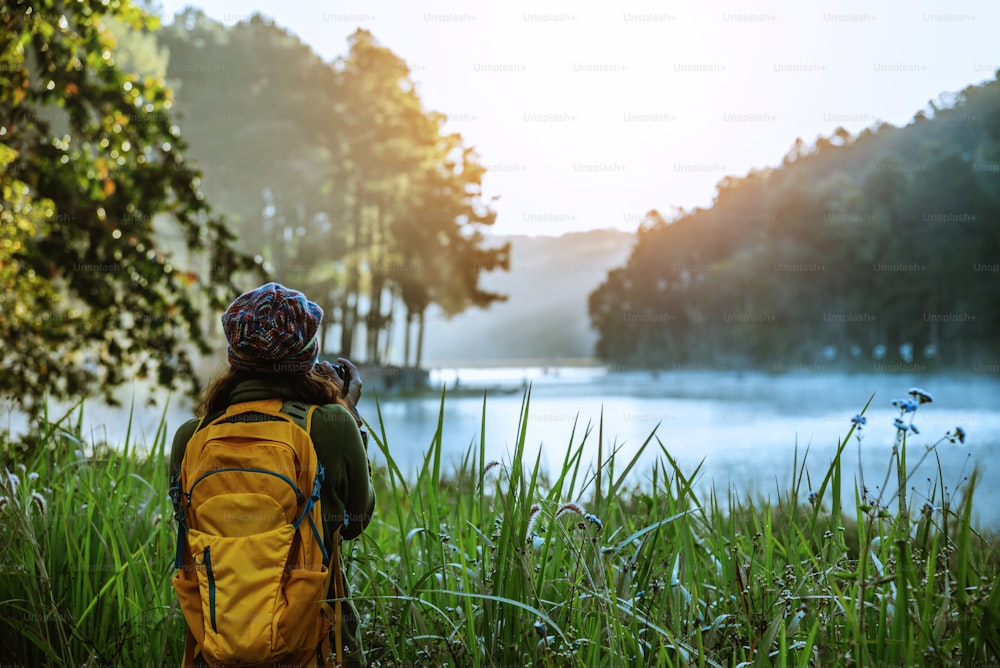 asian women traveller stand take pictures of nature landscape the beautiful in Thailand.