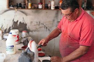 carpenter crafting with wood in his shop