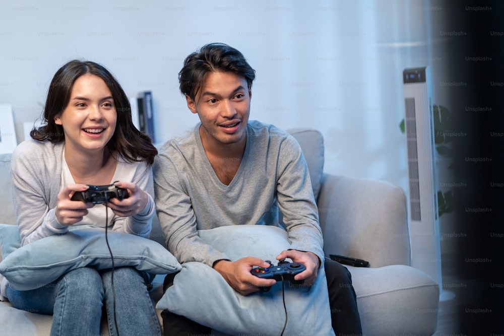 Chinese Girlfriend And Boyfriend Playing Videogame Using Games Console  Sitting On Floor At Home. Computer Gaming And Videogames For Couple, Family  Weekend Leisure Concept Stock Photo, Picture and Royalty Free Image. Image