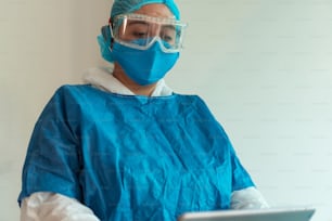 Portrait of a nurse with surgical mask and digital tablet