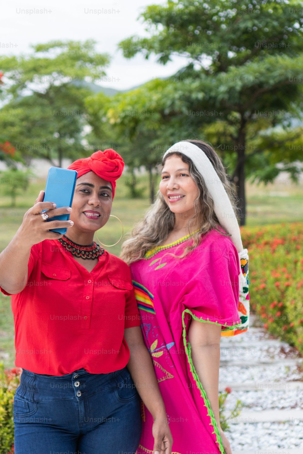 Two indigenou women taking a selfie in a park