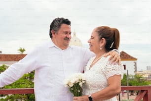 Middle-aged Latin bride and groom hugging