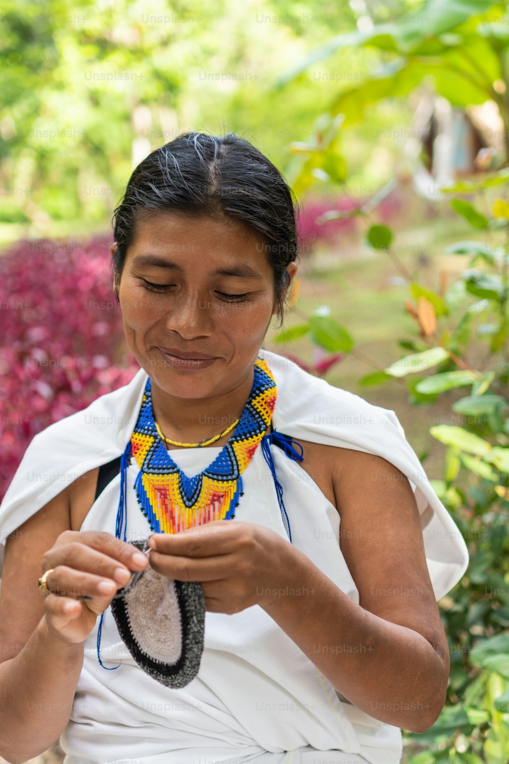 Indigenous woman weaving textiles for sale in Santa Marta, Colombia
