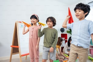 Mixed race Group of young children student playing together in school. Little preschool boy and girl kid feeling happy and fun while spend free time play toys during break in classroom at kindergarten