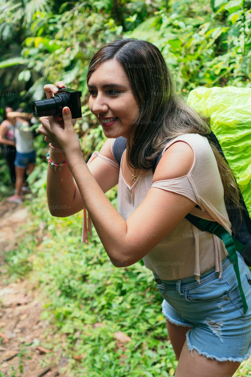 Latin Woman Using Camera In Tropical Forest