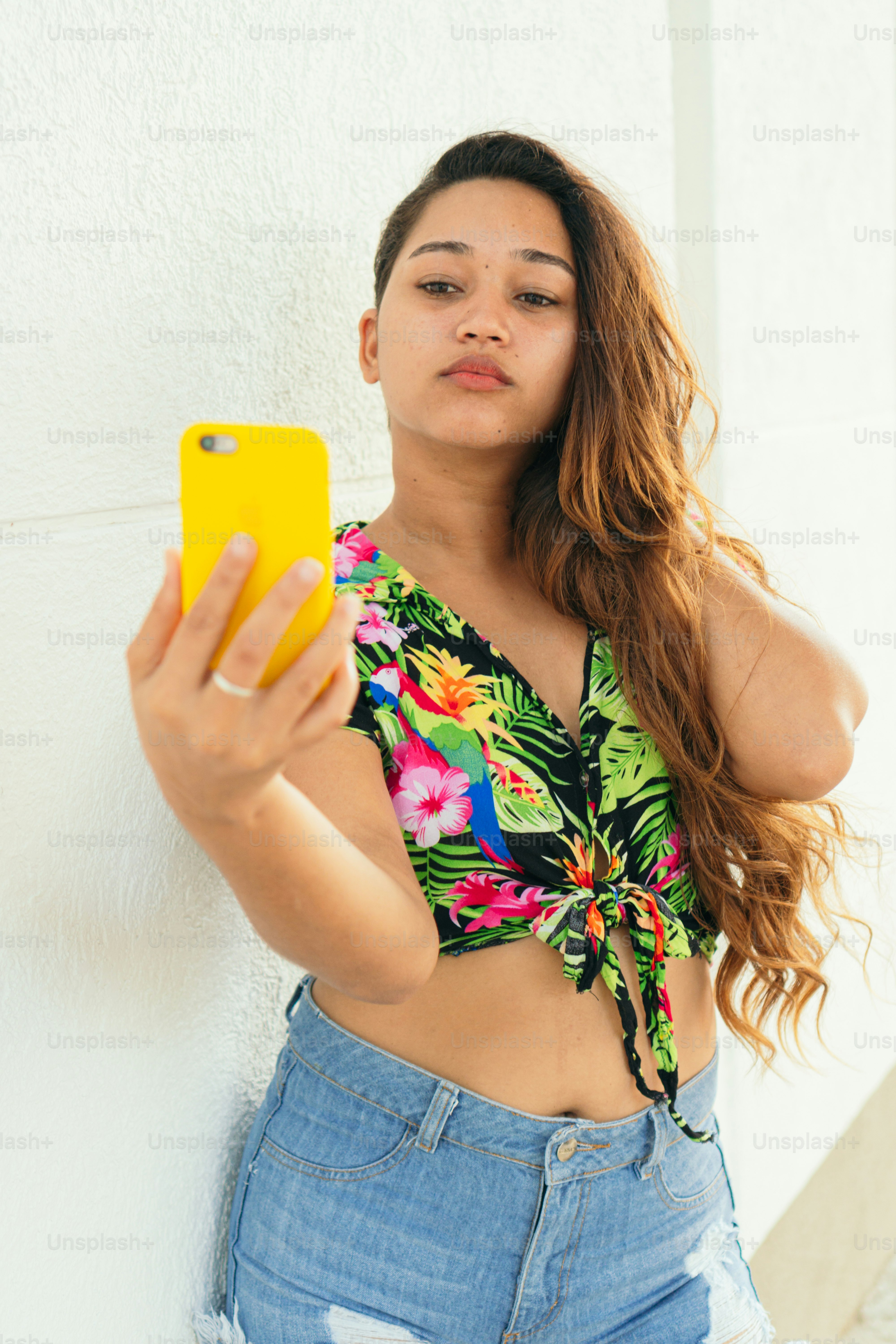 Attractive African woman taking selfie photo on the street