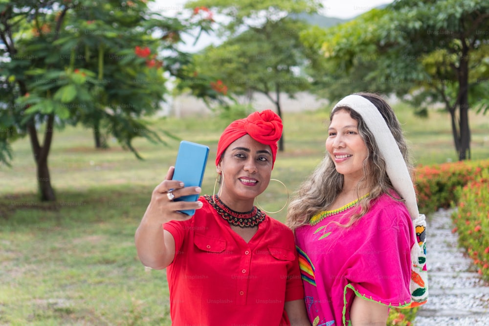 Two multiethnic women taking a selfie in a park