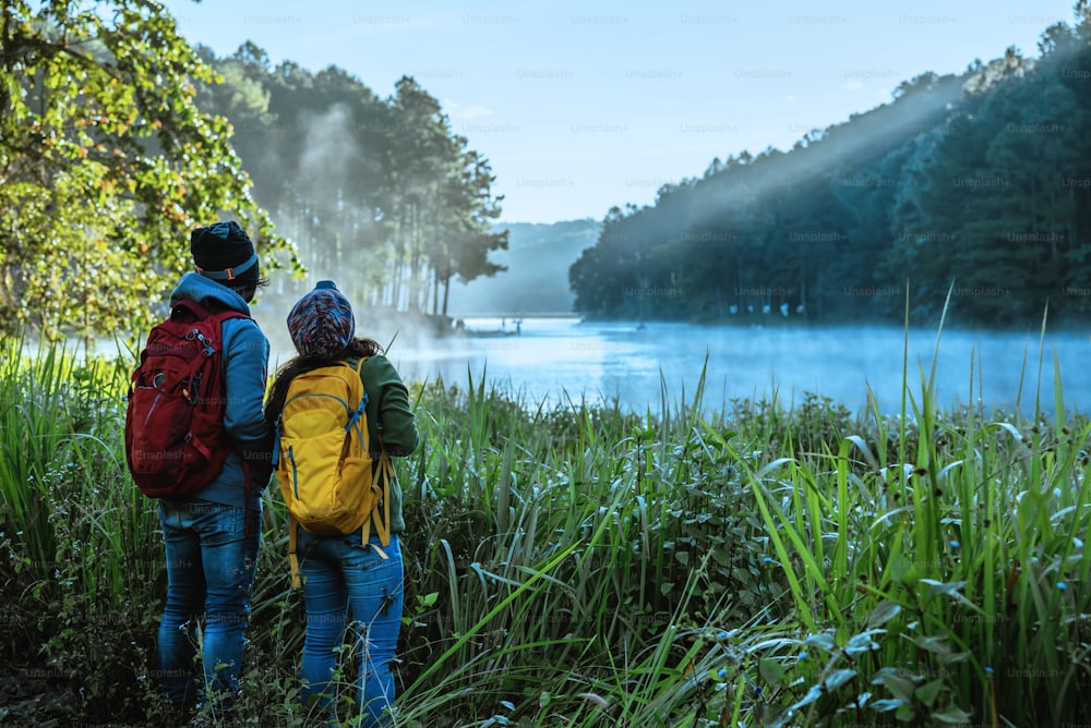 Couples asian Travel, take pictures of nature landscape the beautiful at Pang Ung lake, Thailand.