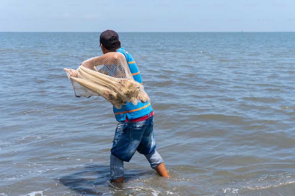 Fisherman casting a net in the sea