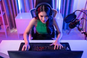 Asiática hermosa mujer jugadora de deportes juega videojuegos en línea en la computadora. Atractiva joven jugadora perdedora de juegos que se siente frustrada y enojada mientras transmite la transmisión en vivo jugando un torneo cibernético.